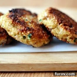 A small stack of golden quinoa patties, perfectly cooked and ready to eat.