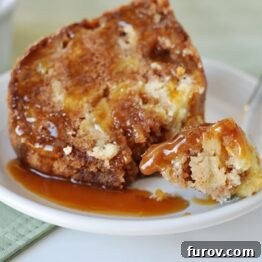 Caramel Apple Bundt Cake slice with a dollop of caramel on top.