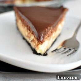 A close-up of a slice of Chocolate Mousse Cheesecake Pie, showing its distinct layers, ready to be enjoyed.