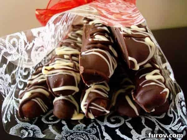 Decadent Chocolate Caramel Pretzel Rods 2 A beautiful stack of white and chocolate dipped pretzel rods, perfectly showcasing their festive appeal.