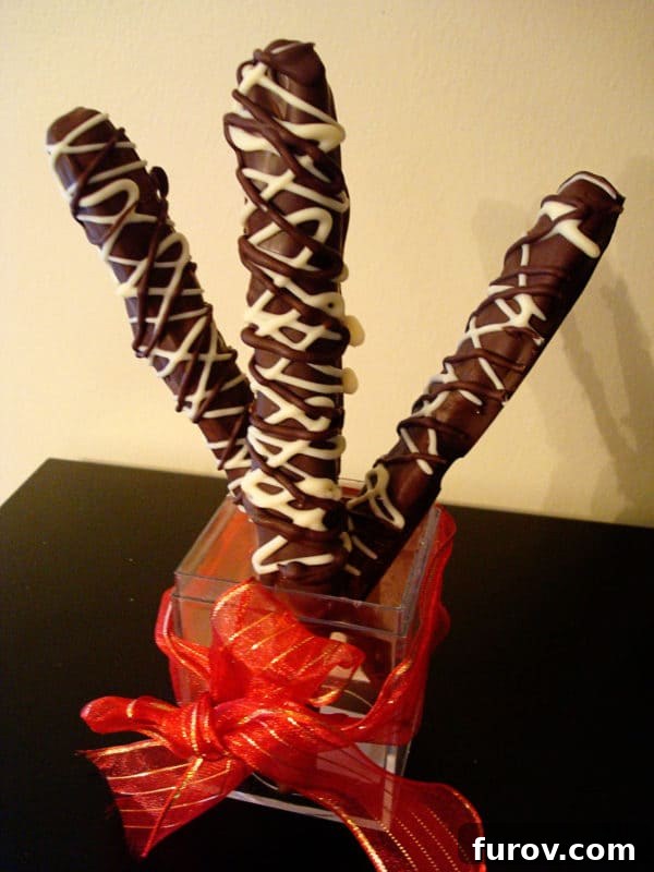 Decadent Chocolate Caramel Pretzel Rods 3 Three elegantly crafted chocolate dipped pretzel rods, beautifully drizzled with contrasting white chocolate for a sophisticated finish.
