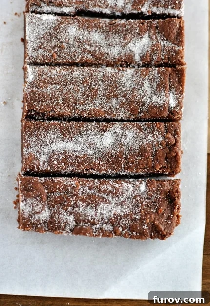 An overhead view of perfectly cut chocolate shortbread fingers, each piece showcasing its rich color and tender texture.