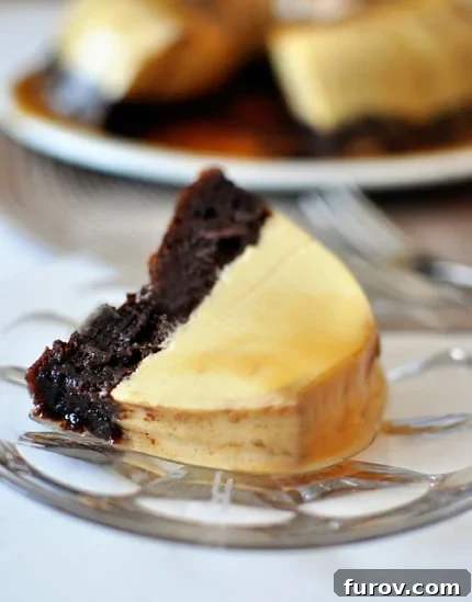 The Impossible Cake 2 A slice of Magic Chocolate Flan Cake with distinct chocolate cake bottom and flan top, adorned with caramel, on a glass plate.
