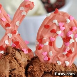 Finished chocolate X and O toppers with sprinkles on a white background, ready to be used.