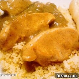 Green Curry Chicken served over couscous, garnished with fresh cilantro.