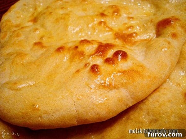Freshly cooked, fluffy naan bread ready to be served with a curry or dip.