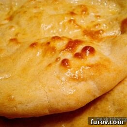 Perfectly cooked Naan bread, golden brown and slightly blistered.
