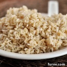 A bowl of fluffy brown rice, ready to be served.