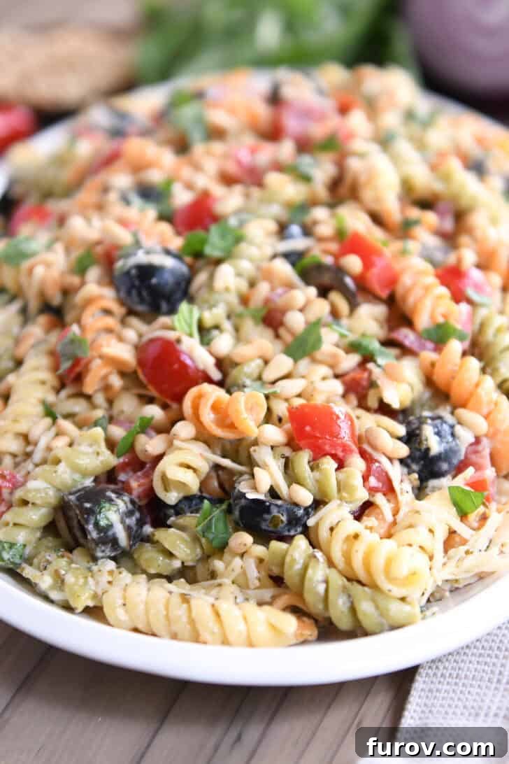 Vibrant Tricolor Pasta Medley 2 Tri-color pasta salad on white platter, showcasing its vibrant colors.