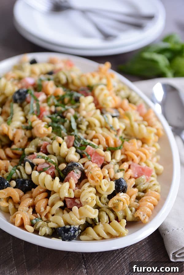 Vibrant Tricolor Pasta Medley 10 A bowl full of tri-color pasta with olives sprinkled throughout.