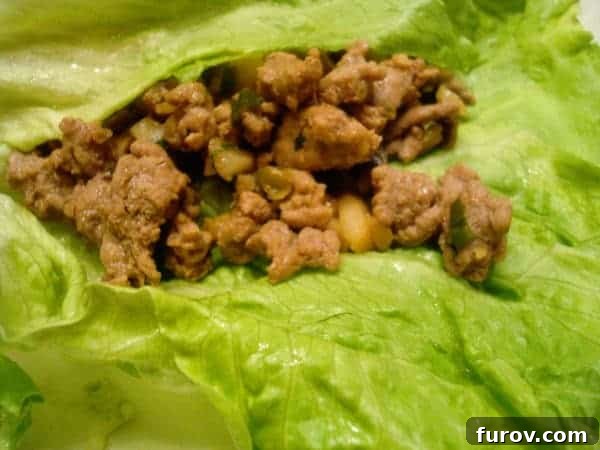 Savory ground turkey filling nestled in a crisp lettuce leaf, ready to be enjoyed as a healthy Asian lettuce wrap.