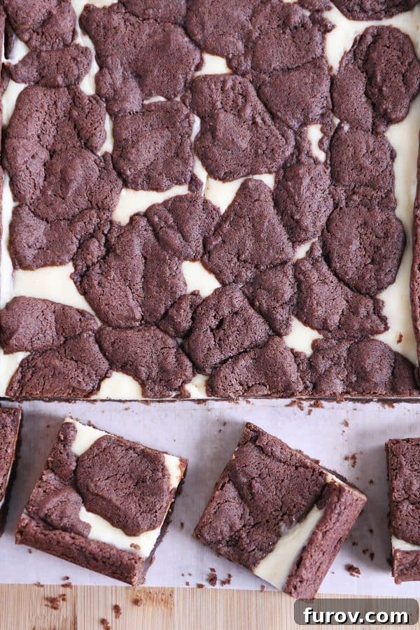 Ebony and Ivory Cheesecake Brownies 3 Pan of baked and cut black and white cheesecake brownies.