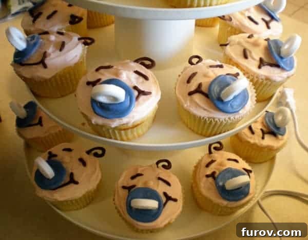 Sweet Baby Bites 2 Cupcakes decorated like babies faces on a cupcake tower.