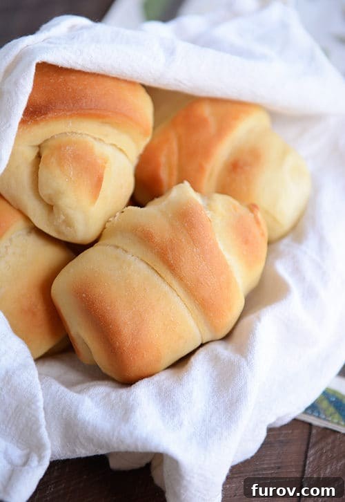 Fluffy Buttermilk Rolls: Prep Now, Enjoy Later 2 A basket full of golden brown baked buttermilk dinner rolls, showcasing their perfect crust and inviting texture.
