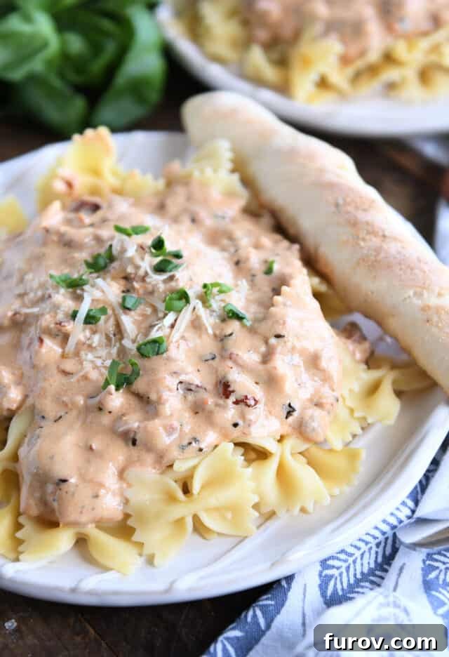 Velvety Tuscan Pasta Sauce Ready in 20 Minutes 2 Creamy Tuscan pasta sauce with freshly grated Parmesan cheese and basil over bowtie pasta.