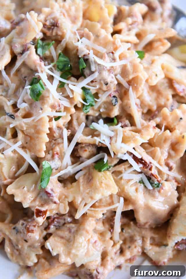 Velvety Tuscan Pasta Sauce Ready in 20 Minutes 4 A delicious medley of bowtie pasta noodles generously coated in creamy Tuscan pasta sauce, adorned with Parmesan and fresh basil.