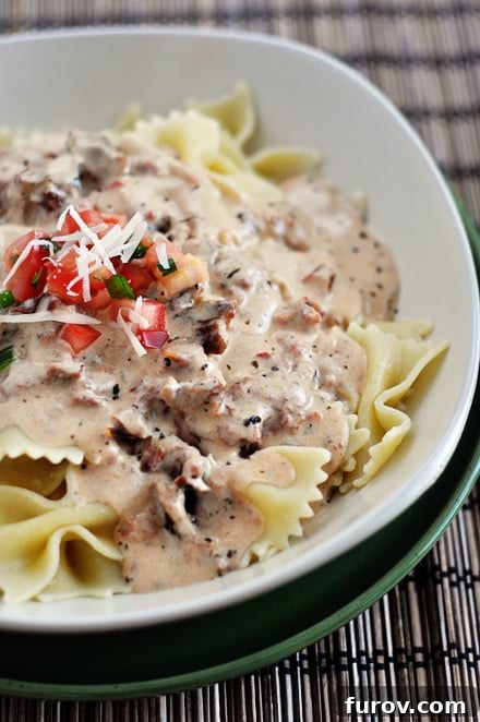 Velvety Tuscan Pasta Sauce Ready in 20 Minutes 7 Cooked bowtie pasta generously topped with creamy Tuscan sauce, ready to serve.