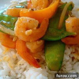 Shrimp Stir Fry with Snow Peas and Coconut Curry Sauce plated for serving.