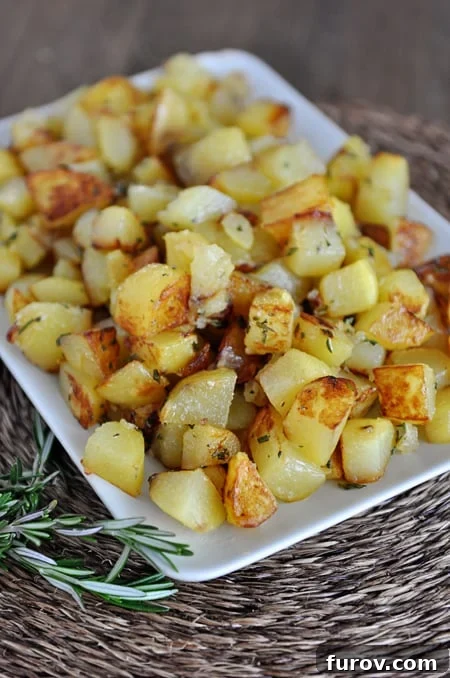 A white dish with golden brown cooked potato cubes, perfectly crisp on the outside.