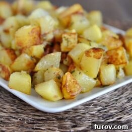 A close-up of golden skillet potatoes, crispy and seasoned.