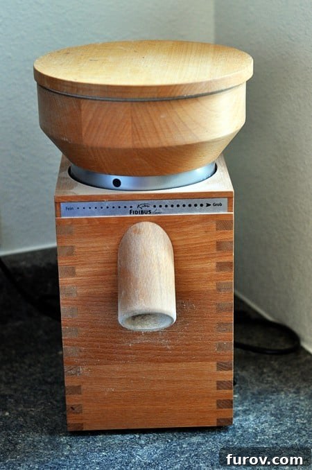 The Essential Guide to Wheat Grinders: 60+ Top Models Reviewed 2 A KoMo wheat grinder on a kitchen counter, showcasing its elegant design.