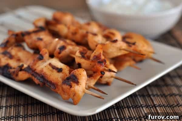 Smoky Chipotle Chicken Skewers with Zesty Avocado Crema 2 White platter with grilled chipotle chicken skewers, perfectly charred and ready to serve.