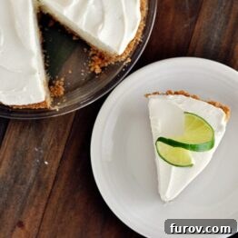 Sour Cream Lime Tart with whipped topping and lime slices.