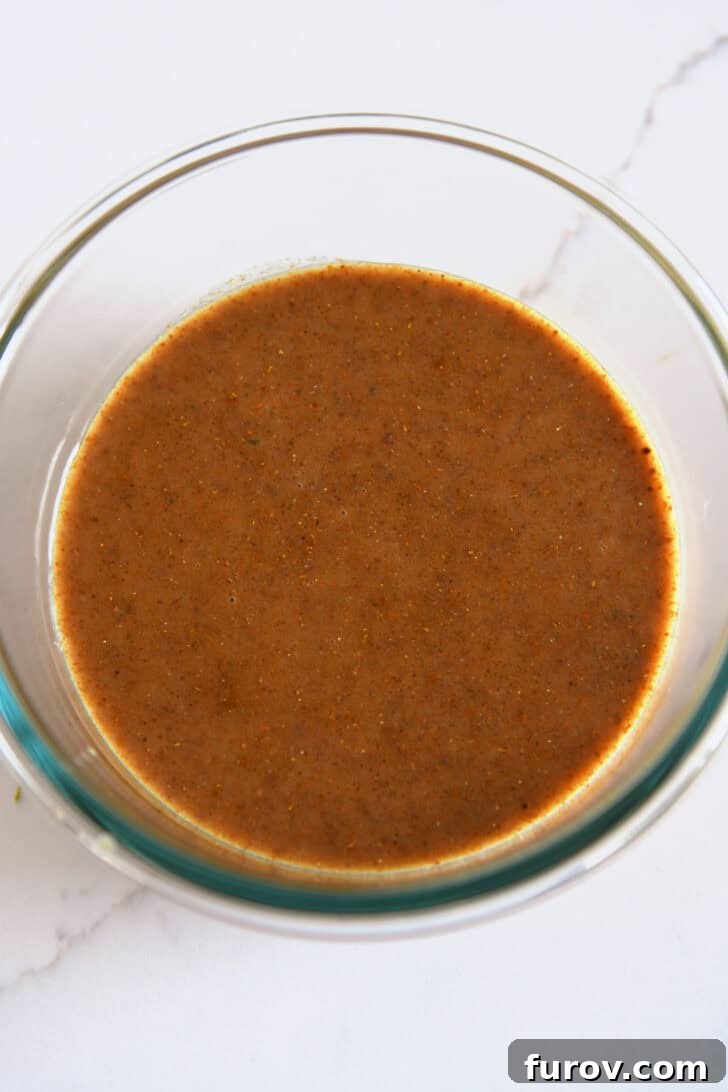 Glass bowl showcasing the complete, beautifully blended curry coconut lime marinade, ready to infuse flavor.