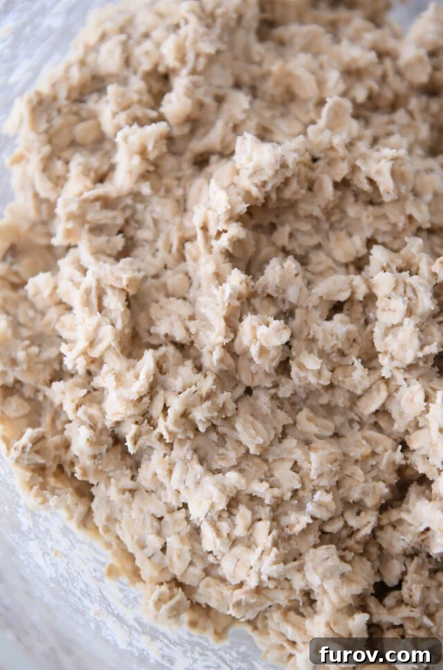 Crisp Oatmeal Thins 4 Close-up of oatmeal cookie dough in a glass bowl, ready for baking.