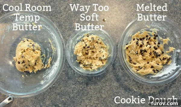 A top-down view of three glass bowls, each containing chocolate chip cookie dough of visibly different consistencies—one firm and cohesive, one slightly looser, and one noticeably more fluid, reflecting the varied butter temperatures used.