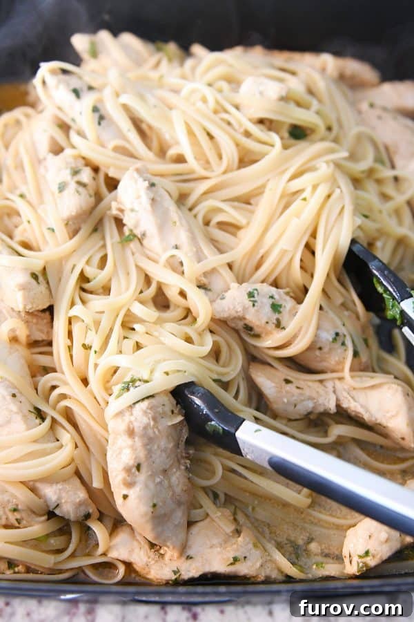 Tossing linguine with cooked chicken and marinade in a large skillet, creating a cohesive and flavorful pasta dish.