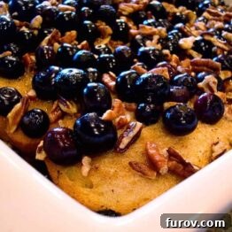 Overhead shot of Baked Blueberry Pecan French Toast in a white baking dish.