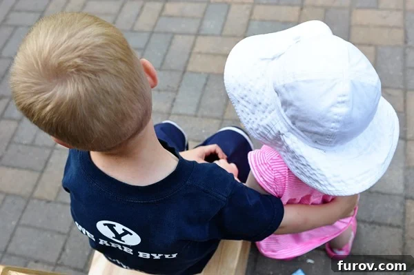 A little boy and a little girl sharing a sweet moment together, symbolizing sibling affection and the grounding nature of family
