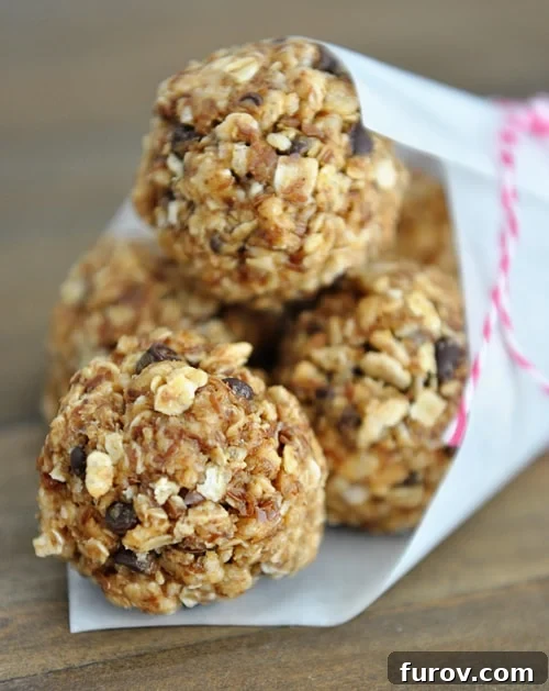 A pristine white paper cone brimming with chocolate chip granola bites, ready for a healthy snack.