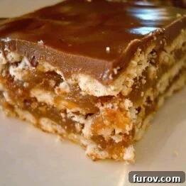 Close-up of a caramel crunch bar, showcasing its layers of crackers, caramel, and chocolate-butterscotch topping.