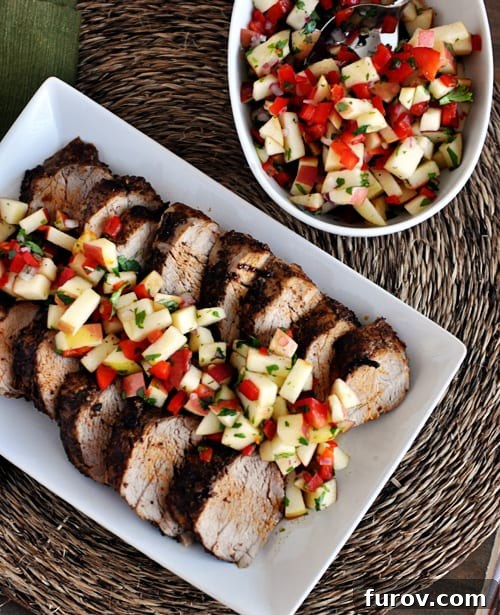 Cinnamon-Chili Rubbed Pork Tenderloin with Zesty Apple Salsa 4 Top view of grilled pork loin slices with a fresh apple salsa on top.