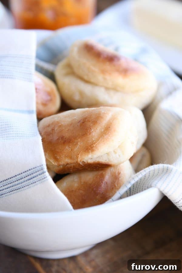 Cloud-Soft Parker House Rolls 2 Baked fluffy 2-hour Parker house rolls in basket with towel.
