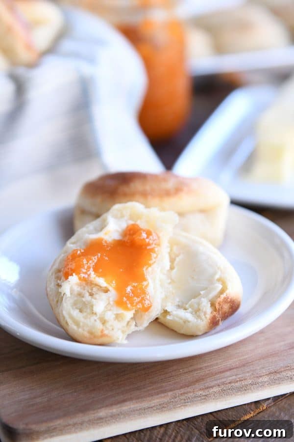 Cloud-Soft Parker House Rolls 7 Fluffy Parker house roll in half with butter and apricot jam.