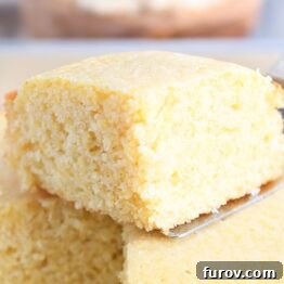 A golden-brown slice of the best homemade cornbread.