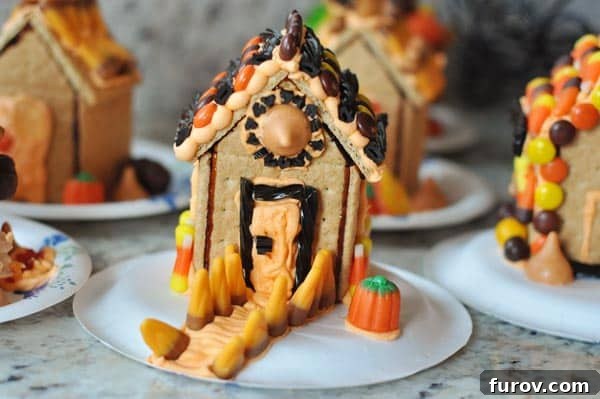 A collection of beautifully decorated Halloween haunted houses made from graham crackers, showcasing various spooky and whimsical designs