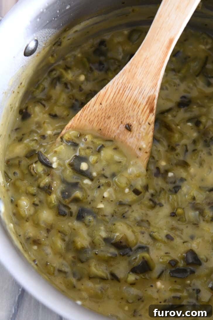 A metal pot with vibrant green enchilada sauce gently cooking, a wooden spoon stirring it to perfect consistency.