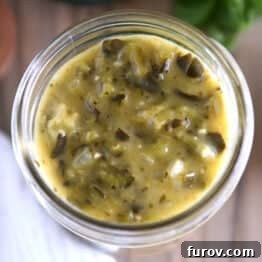 Top view of a glass jar filled with luscious green enchilada sauce.