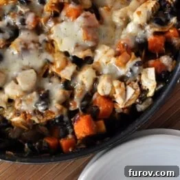 A close-up of the Black Bean and Butternut Enchilada Skillet in a cast iron pan.
