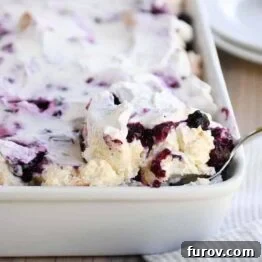 Scooping out a serving of heavenly blueberries and cream angel food cake dessert.