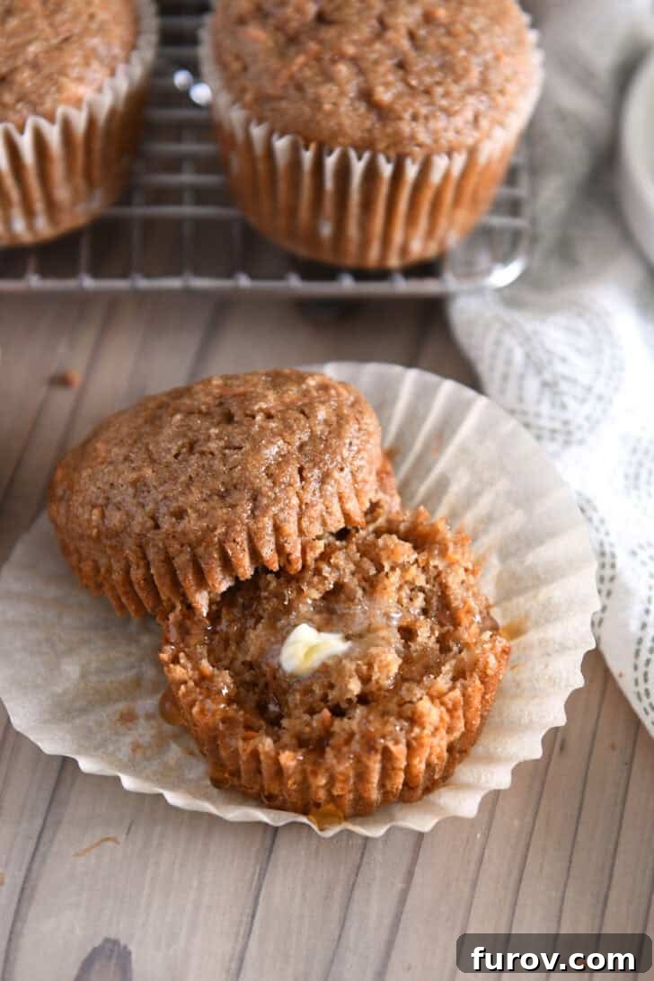 Healthy Carrot Cake Muffins with Applesauce 8 A healthy carrot cake muffin split in half, ready to be enjoyed with butter and honey.