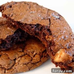 A close-up of a chocolate toffee cookie, highlighting its rich color and textured surface.