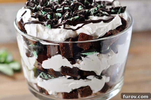 Ultimate Mint Oreo Trifle with Fudge Brownie Layers and Creamy Mint Swirl 4 Close-up side view of a layered Mint Brownie and Oreo Hot Fudge Trifle in a glass dish, showing the distinct alternating layers.