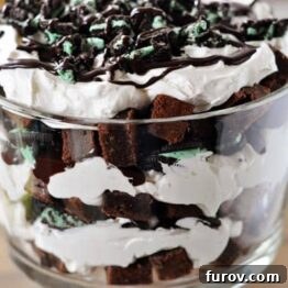 A top-down view of the layered Mint Brownie and Oreo Hot Fudge Trifle with a spoon digging in.