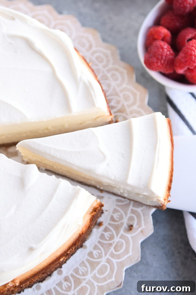 Pulling slice of cheesecake out of whole cheesecake.