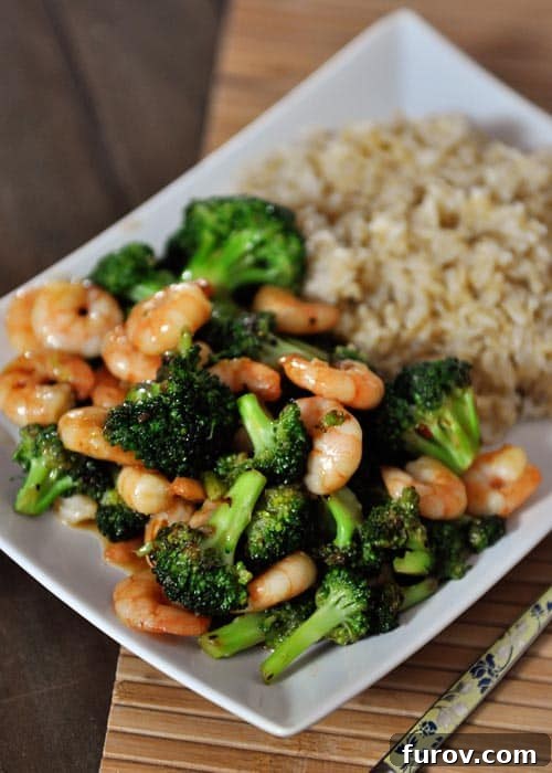 Broccoli and Brown Rice Stir-Fry: Plant-Powered or Protein-Packed 2 A beautiful white platter full of perfectly cooked broccoli florets and tender shrimp, artfully arranged next to a serving of fluffy, wholesome brown rice.